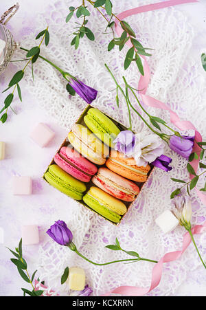 Colorful macaroons and marshmallows on a ligth  background. Flat lay. Top view Stock Photo