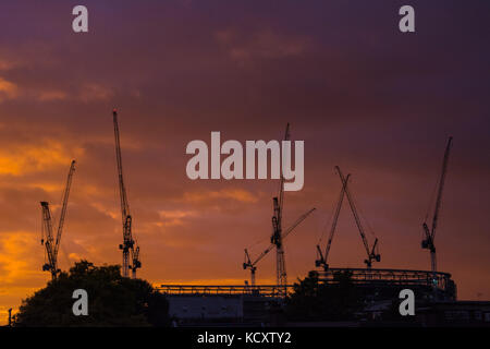 Tottenham, London, UK. 7th Oct, 2017. UK Weather. Cranes involved in the building works at the new Tottenham Hotspur stadium are silhouetted against a dramatic sunset. Credit: Patricia Phillips/Alamy Live News
