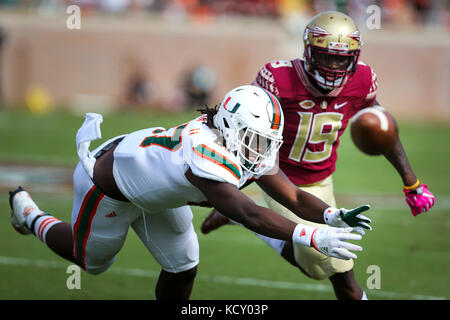Miami tight end Michael Irvin II (87) is upended by defensive back