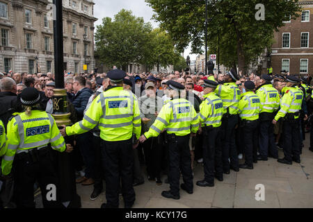 London, UK. 7th October, 2017. Supporters of the Football Lads Alliance (FLA) move past anti-racist campaigners from  Stand Up To Racism outside Downing Street during their second 'march against extremism' from Park Lane to Westminster Bridge. The FLA was formed following the London Bridge terror attack on 3rd June. Credit: Mark Kerrison/Alamy Live News Stock Photo