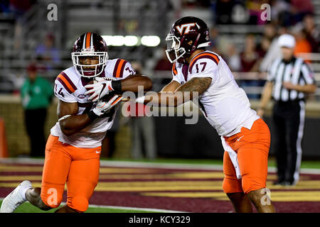 Chestnut Hill, Mass. 7th Oct, 2017. Virginia Tech Hokies quarterback Josh Jackson (17) hands off the ball to running back Travon McMillian (34) during the NCAA division 1 football game between the Virginia Tech Hokies and the Boston College Eagles, held at Alumni Stadium, in Chestnut Hill, Mass. Eric Canha/CSM/Alamy Live News Stock Photo