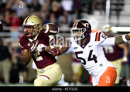 Chestnut Hill, Mass. 7th Oct, 2017. Virginia Tech Hokies linebacker Andrew Motuapuaka (54) punches the ball out of Boston College Eagles running back AJ Dillon's (2) arm during the NCAA division 1 football game between the Virginia Tech Hokies and the Boston College Eagles, held at Alumni Stadium, in Chestnut Hill, Mass. Eric Canha/CSM/Alamy Live News Stock Photo