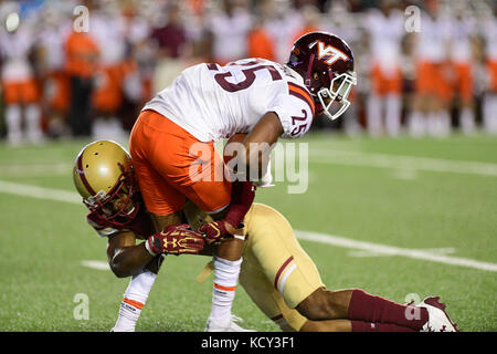 Chestnut Hill, Mass. 7th Oct, 2017. Boston College Eagles defensive back Taj-Amir Torres (24) tackles Virginia Tech Hokies cornerback Greg Stroman (25) during the NCAA division 1 football game between the Virginia Tech Hokies and the Boston College Eagles, held at Alumni Stadium, in Chestnut Hill, Mass. Virginia Tech defeats Boston College 23-10. Eric Canha/CSM/Alamy Live News Stock Photo