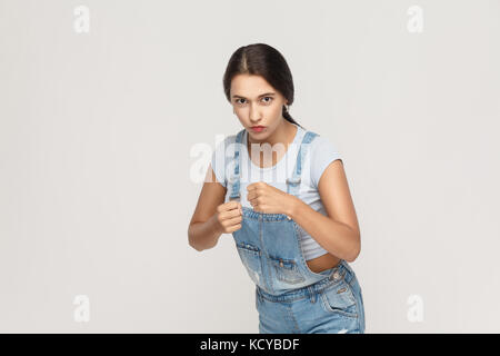 Boxing. Young adult indian woman, ready for fight on gray background. Stock Photo