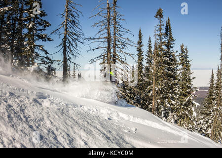 Snowboarder ride on powder snow to the mountains. Winter sports freeride. Stock Photo
