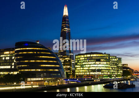 City Hall and The Shard at sunset with river Thames in foreground, London, United Kingdom Stock Photo