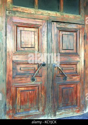 Closeup of old textured wooden door with handle. Stock Photo