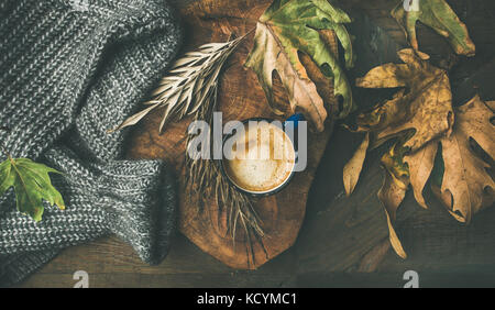 Autumn morning coffee concept with leaves and woolen sweater Stock Photo