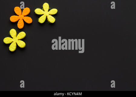 of felt flowers on dark background. Stock Photo