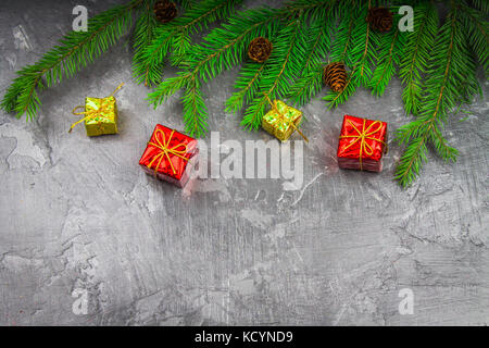 Christmas tree branch with a toy on a gray background. Stock Photo