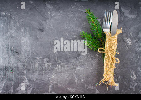 Fork with a knife in the sacking on a gray background. Stock Photo