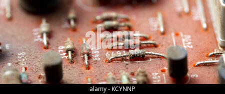 Part of old vintage printed circuit board with electronic components. Stock Photo