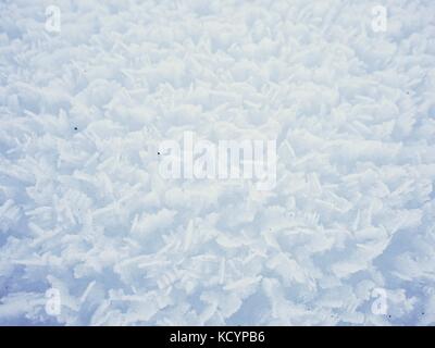Stucture of crystal snow surface from very close distance.  Frozen snow flakes stick together into rough sharp structure Stock Photo