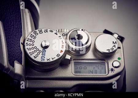 Buttons, display and shutter control dial on SLR camera closeup Stock Photo