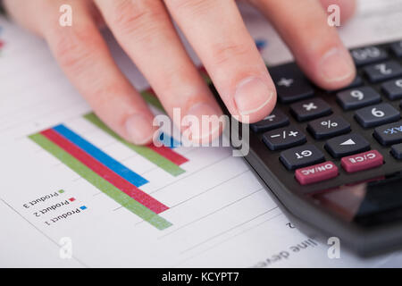Close-up Of A Businessman Hand Analyzing Stock Charts Stock Photo