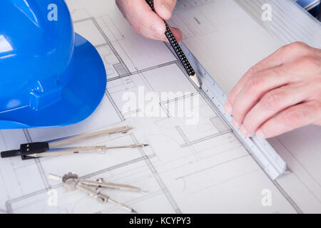 Portrait Of Mature Architect Male With Blueprint In The Office Stock Photo