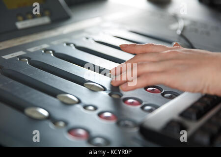 Radio Host Using Music Mixer In Studio Stock Photo