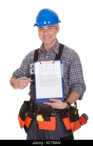 Happy Technician Pointing On Clipboard Over White Background Stock Photo