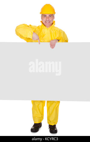 Mature Man Wearing Raincoat And Standing Behind Placard Over White Background Stock Photo