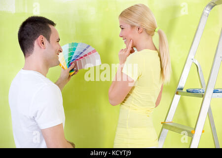 Smiling couple with color samples to paint their new house Stock Photo