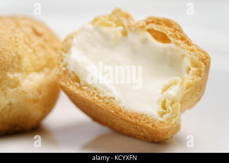 profiteroles on plate closeup one sliced Stock Photo