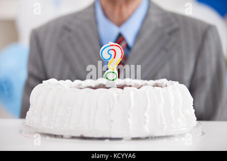 birthday cake with a question mark candle Stock Photo