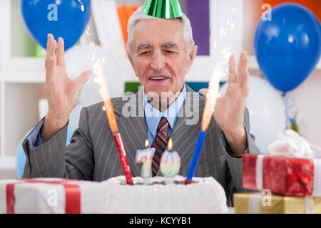 Happy senior man celebrating 70th birthday Stock Photo