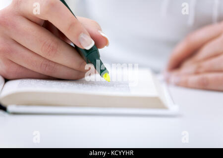 Writing,  hand who writes with an highlighter on paper Stock Photo