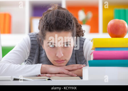 sad schoolgirl with learning difficulties with books Stock Photo