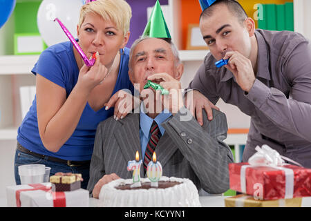 Happy family celebrating 70th birthday Stock Photo