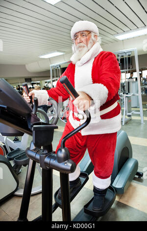 Santa Claus  doing exercises before delivering presents Stock Photo