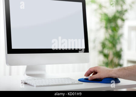 Men hand using computer mouse with blank  computer screen Stock Photo