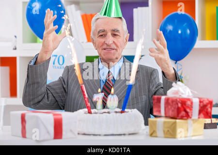 senior man celebrating 70th birthday Stock Photo