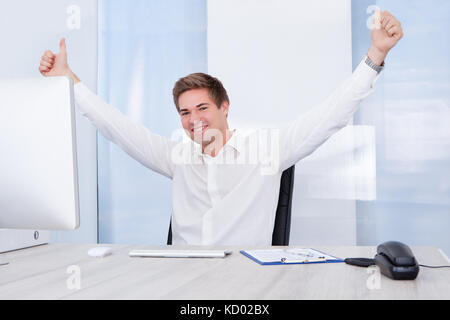 Happy Young Successful Businessman Raised Hand With Thumb Up Stock Photo