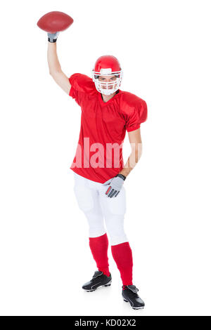 American Football Player Holding Rugby Ball On White Background Stock Photo