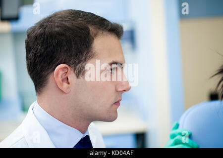 Handsome cheerful young dentist Stock Photo