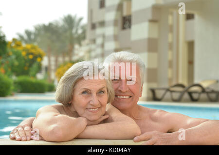 Senior couple relaxing at pool Stock Photo