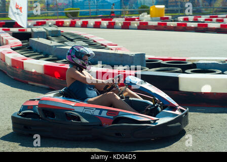 RUSSIA, SOCHY - SEPTEMBER 20, 2017. amateur girl in a purple helmet is racing in a rented kart on a equipped track Stock Photo