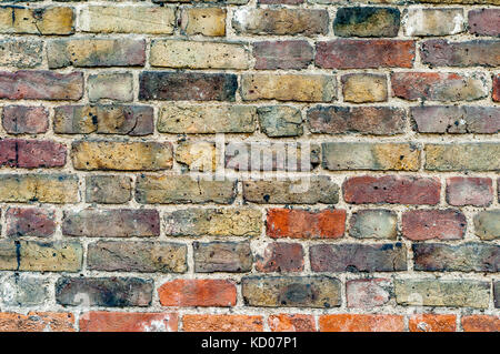 Aged brick wall background texture with a mixture of red, orange and black bricks Stock Photo