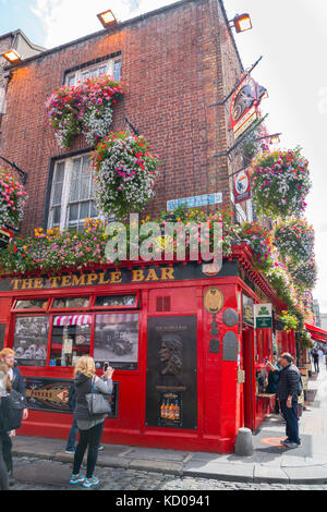 DUBLIN, IRELAND - AUGUST 10, 2017; Tourists wander the streets of Temple Bar area a popular travel destination with quaint old buildings, bars and sho Stock Photo