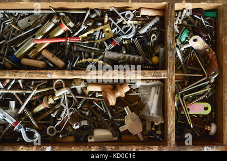 Some nuts and bolts and other metallic pieces in a wooden box. Top view and empty copy space for Editor's text. Stock Photo
