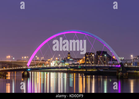 Night lights and the Clyde Arc Bridge at Glasgow City in Scotland over river. Stock Photo