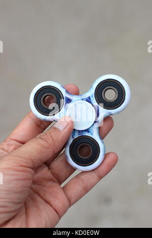 Close up of hand holding fidget spinner Stock Photo
