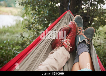 Feet of couple relaxing in hammock, Krakow, Malopolskie, Poland, Europe Stock Photo