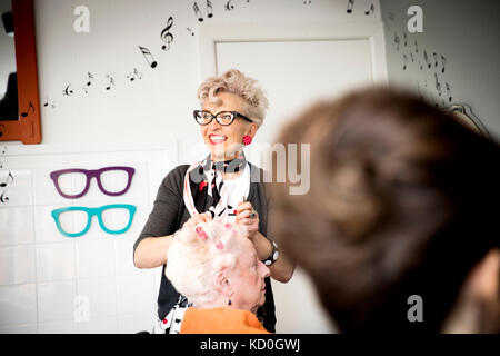 Woman working in quirky hair salon Stock Photo