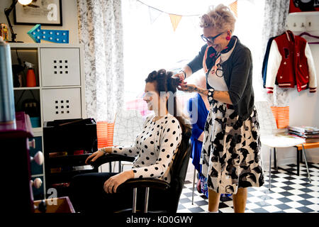 Woman working in quirky hair salon Stock Photo