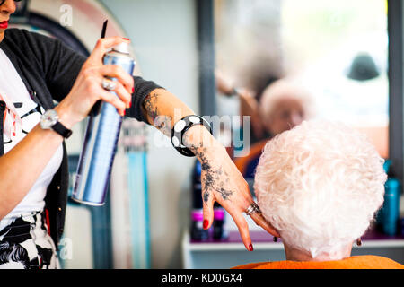 Woman working in quirky hair salon Stock Photo