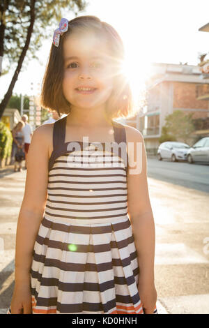 Portrait of girl in street looking at camera smiling Stock Photo