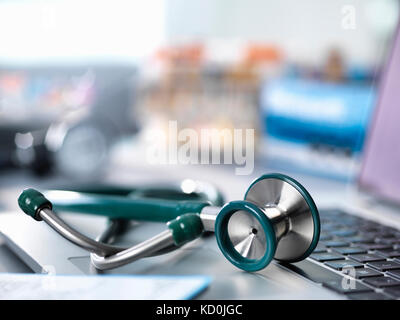 Stethoscope on doctors desk in a clinic Stock Photo