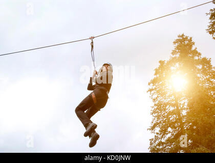 Teenage girl on zip wire Stock Photo